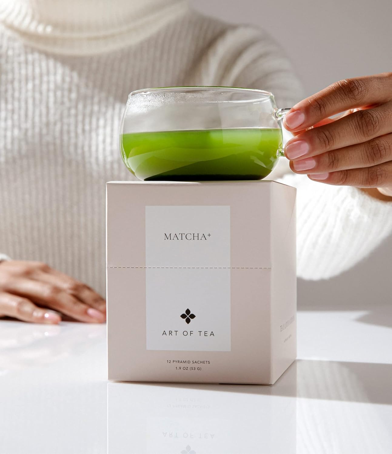 bright green tea in a modern glass tea cup